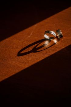 Gold wedding rings for newlyweds on their wedding day. Jewelry for the holiday of a couple in love