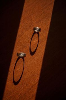 Gold wedding rings for newlyweds on their wedding day. Jewelry for the holiday of a couple in love