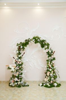 Wedding decor made of flowers and fabric. Beautiful decorations for newlyweds on their wedding day