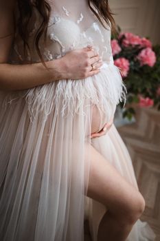 Photo pregnant girl, pregnancy, close-up, pink dress