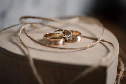 Gold wedding rings for newlyweds on their wedding day. Jewelry for the holiday of a couple in love