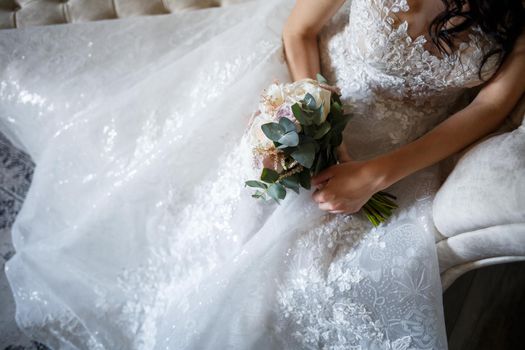 Beautiful wedding bouquet of flowers in the hands of the newlyweds