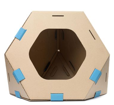 Brown cardboard modular house with a hole for cats and animals isolated on a white background
