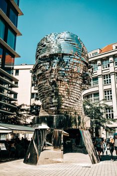 Prague, Czech Republic - July 2022. Moving mirror statue of Franz Kafka by David Cerny. Big metalmorphosis head sculpture. High quality photo