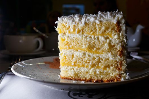 Delicious sweet piece of coconut cake with biscuit cakes