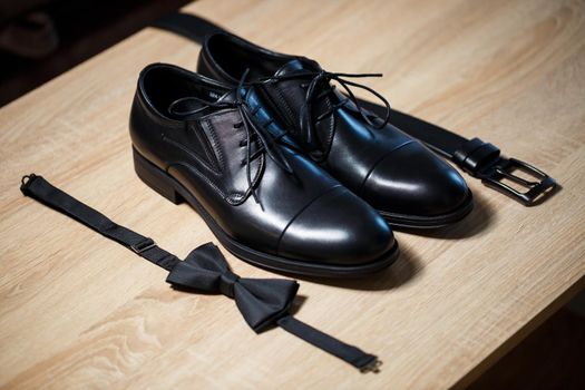 Morning details of a stylish groom with leather shoes