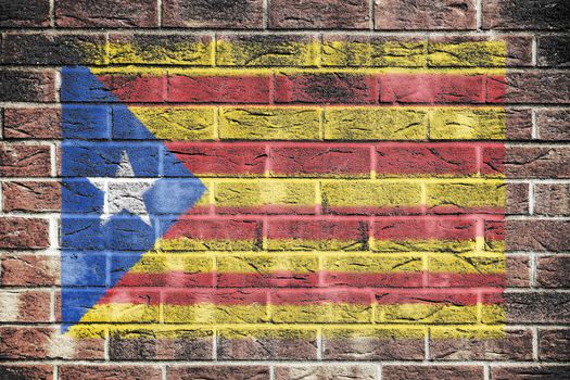 A Catalonia independence flag on brick wall background red yellow blue white star Estelada