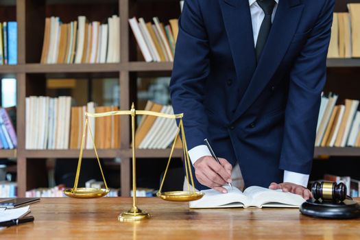 Lawyer businessman reading law book and agreement contract.