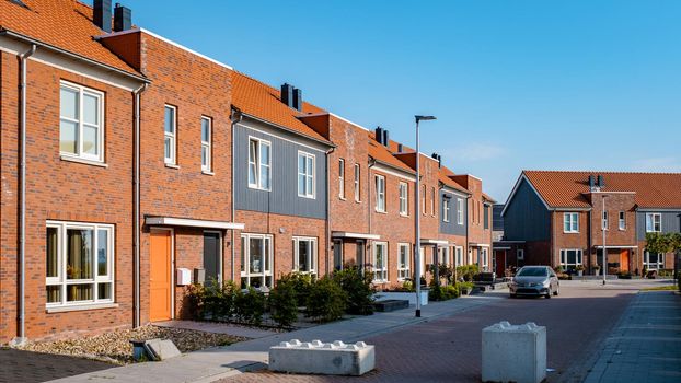 Dutch Suburban area with modern family houses, newly build modern family homes in the Netherlands, dutch family houses in the Netherlands, newly build streets with modern houses.