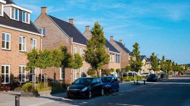 Dutch Suburban area with modern family houses, newly build modern family homes in the Netherlands, dutch family houses in the Netherlands, newly build streets with modern houses.