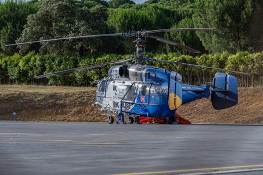 firefighting helicopter parked at the heliport waiting for a forest fire warning.