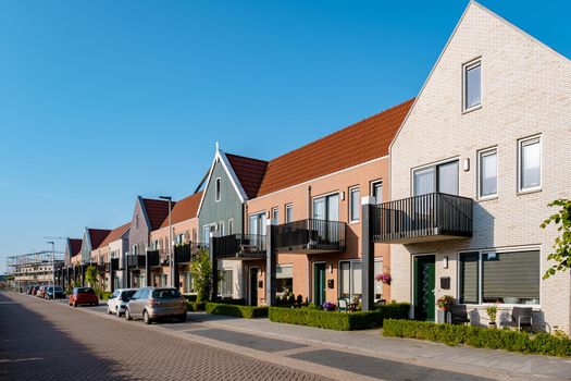 Dutch Suburban area with modern family houses, newly build modern family homes in the Netherlands, dutch family houses in the Netherlands, newly build streets with modern houses.