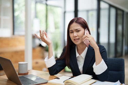 businesswoman showing a serious expression while talking on the phone.