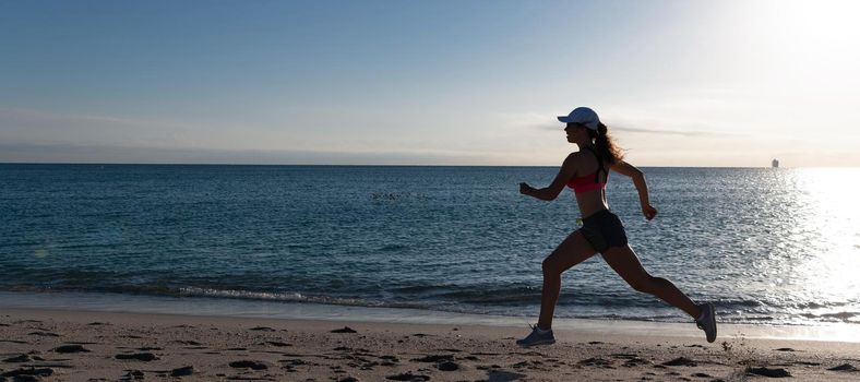 Woman run and jump on sea beach. Running is my favorite. Fit girl run along seaside. Woman runner. Trail running. Jogging activities