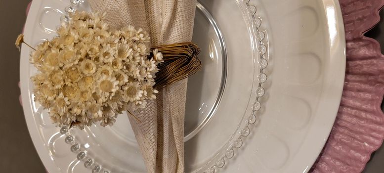 dining table decorated with flowers and pink napkins in Brazil