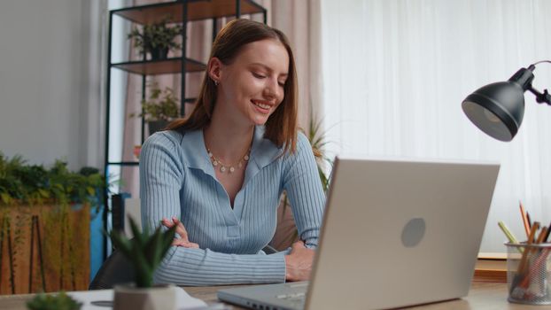 Young woman freelancer sitting at home office desk making video call chat conversation conference use laptop. Adult girl student study working online remote distance job, talking, briefing by webcam