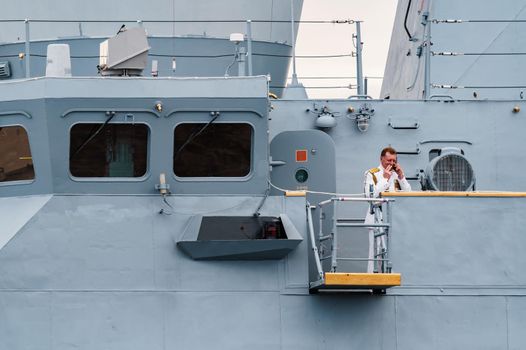 Russia, St. Petersburg, 31 July 2022: The commander of a warship standing in the center of the city, he is dressed in a festive white uniform, celebration of the day of Navy. High quality photo