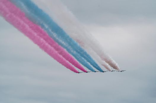 Russian Air Force planes paint the colors of the Russian flag in the sky on St. Petersburg during the celebration of the Day of the Navy. High quality photo