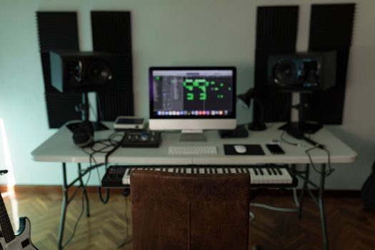 The chair of a music producer dominates the scene amongst the other tools that conform an average home studio