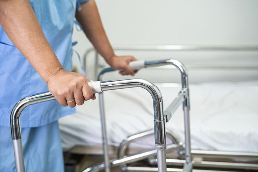 Asian lady woman patient walk with walker at nursing hospital ward, healthy strong medical concept