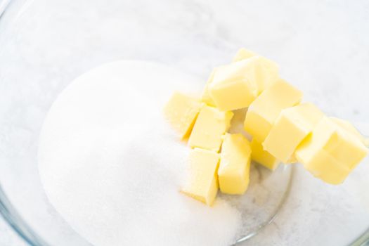 Mixing ingredients in a glass mixing bowl to bake July 4th bundt cake with chocolate stars.