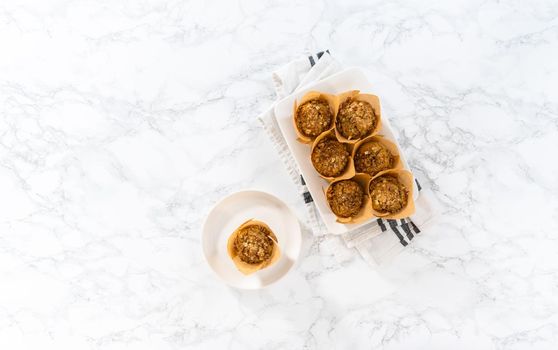 Flat lay. Freshly baked banana oatmeal muffins with oatmeal sugar topping.