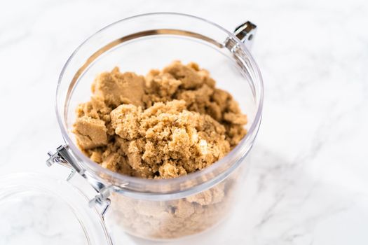 Light brown sugar on a marble counter top.