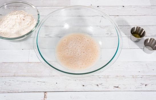 Preparing homemade pizza dough from all-purpose flour.