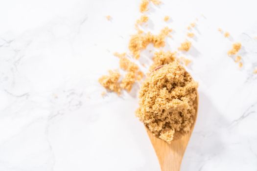 Light brown sugar on a marble counter top.