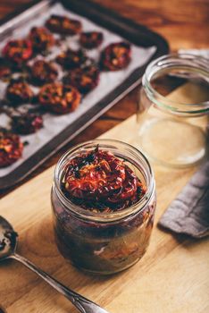 Preserving of Oven Baked Tomatoes with Garlic and Thyme in a Glass Jar