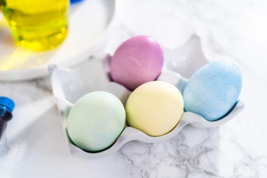 Coloring hard-boiled white eggs with natural food coloring.