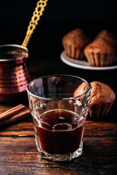 Turkish coffee with spices and oatmeal muffins on wooden surface