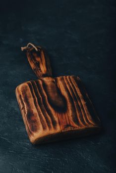 Small Handcrafted Cutting Board on Dark Concrete Surface