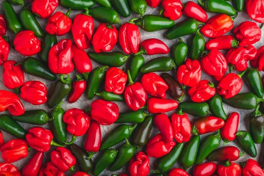 Background of Colorful Jalapeno and Habanero Peppers on Light Background