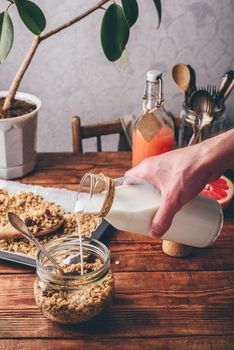 Healthy breakfast with granola, milk and juice