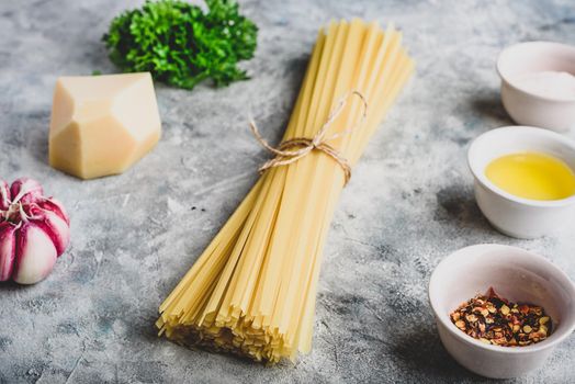 Raw ingredients for cooking linguine with olive oil, garlic and parsley