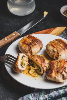 Bacon-wrapped button mushrooms stuffed with grated cheddar cheese and spices