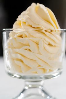 Homemade whipped cream in a class ice cream bowl.