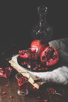 Shots of pomegranate liqueur with fresh fruit