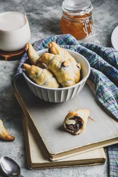 Bowl of fresh baked croissants stuffed with nuts and chocolate spread