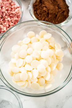 Measured ingredients in a glass mixing bowl to prepare peppermint white chocolate cookies.