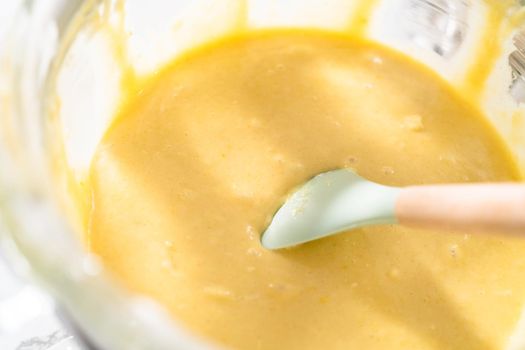 Lemon pound cake batter in a glass mixing bowl.