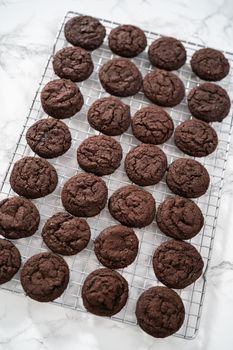 Cooling freshly baked chocolate cookies on a kitchen counter.