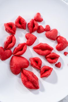 Red chocolate hearts and lips to decorate chocolate cake.