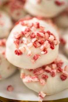 Freshly baked peppermint white chocolate cookies on a white plate.