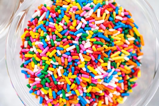 Close up view. Ingredients in glass mixing bowls to bake funfettti bundt cake.