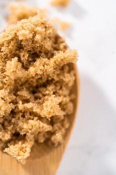 Light brown sugar on a marble counter top.