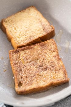 Frying french toast in a nonstick frying pan.