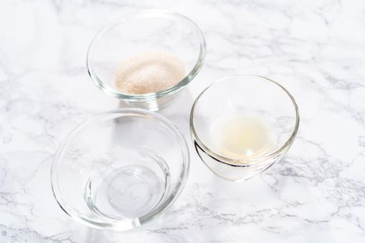 Ingredients in a glass mixing bowls to bake a lemon pound cake.