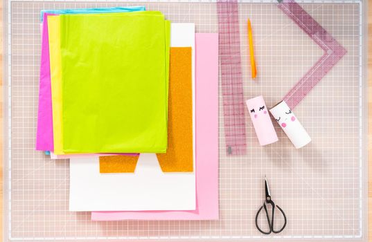 Flat lay. Making a unicorn out of the toilet paper roll and craft paper.